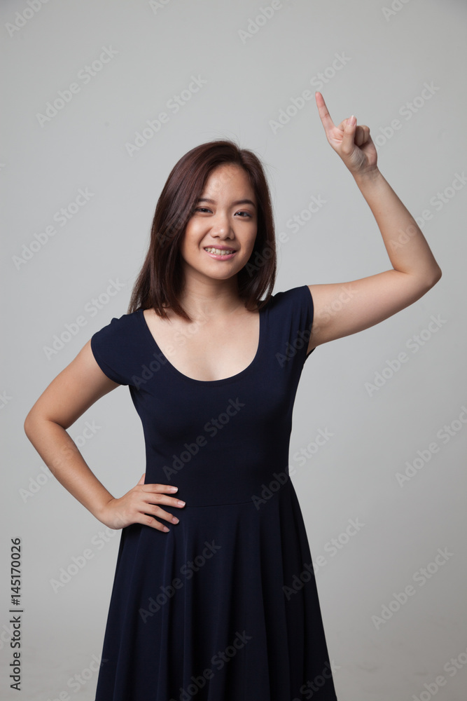 Young Asian woman smile and point up. Young Asian woman smile and point up.