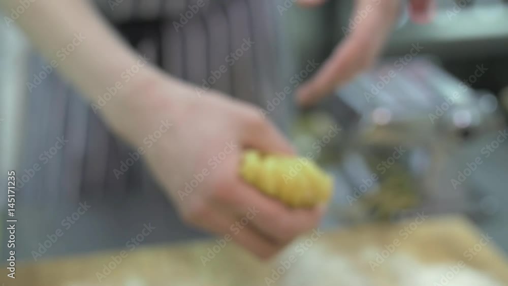 Typical Italian freshly prepared pasta in the hands of the chef, put on the table with flour, slow mo, close-up. Chef twists pasta Typical Italian freshly prepared pasta in the hands of the chef, put on the table with flour, slow mo, close-up. Chef twists pasta