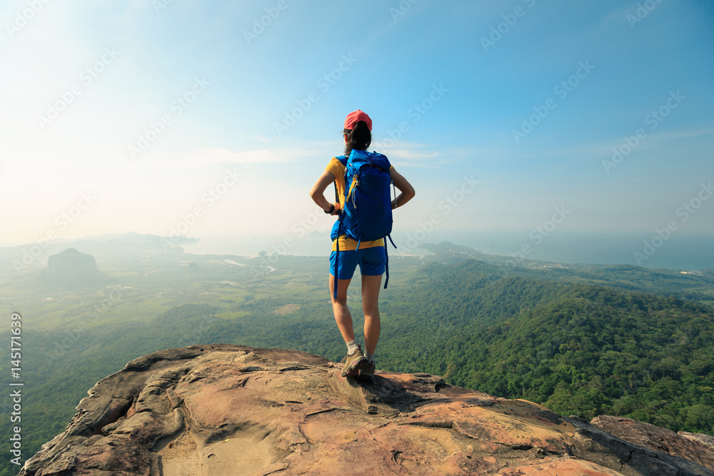 Obraz premium young woman backpacker enjoy the view on mountain peak
