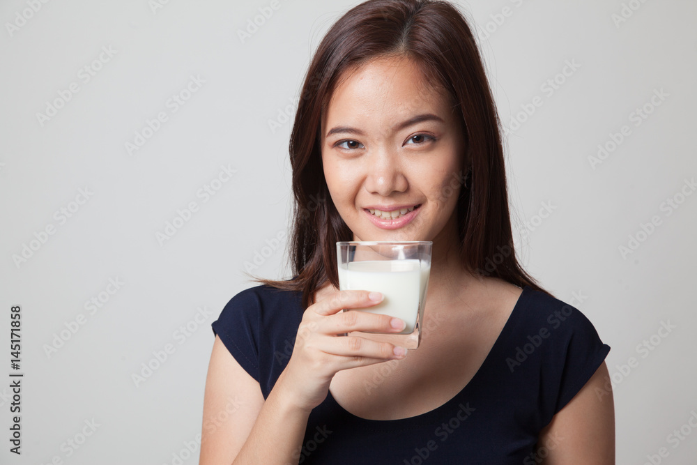 Healthy Asian woman drinking a glass of milk. Healthy Asian woman drinking a glass of milk.