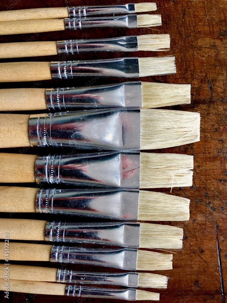 Fototapeta premium Paintbrushes on wood background