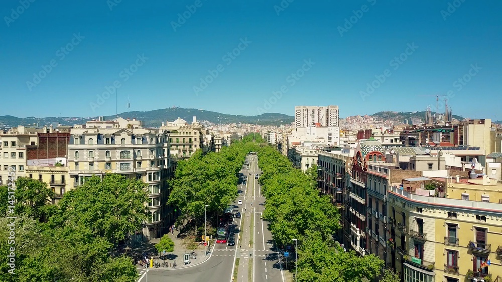 Barcelona major street aerial view, Spain. Distant Sagrada Familia basilica to the right