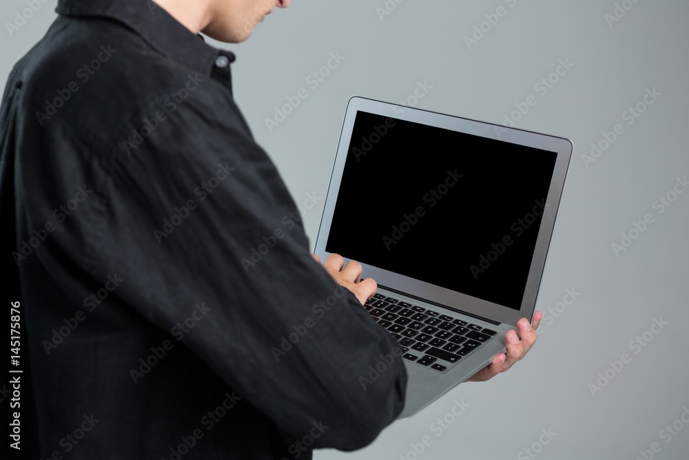 Androgynous man using laptop Androgynous man using laptop