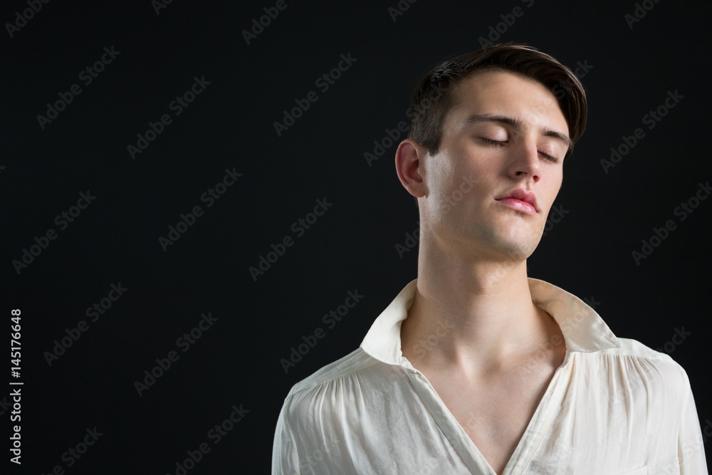 Androgynous man posing with his eyes closed Androgynous man posing with his eyes closed