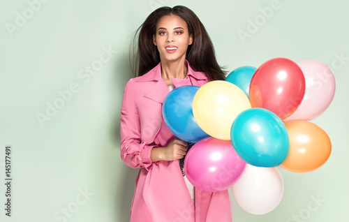 Happy young woman with balloons.