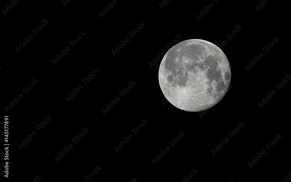 Full Moon in the dark night, black background, isolated. Detailed craters. Right side. Copy space. Full Moon in the dark night, black background, isolated. Detailed craters. Right side. Copy space.