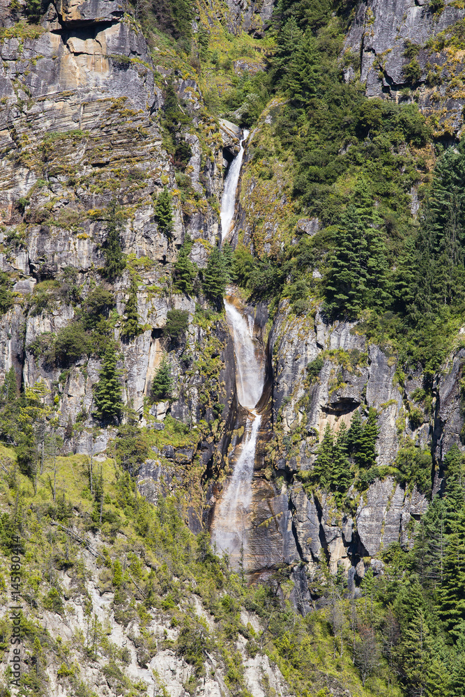 Majestic mountain and waterfall in Himalayas mountains in Nepal Majestic mountain and waterfall in Himalayas mountains in Nepal