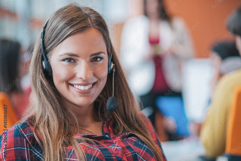 happy young business woman with her staff, people group in background at modern bright office indoors happy young business woman with her staff, people group in background at modern bright office indoors