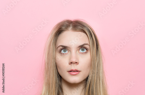 close-up portrait of woman with beautiful eyes and eyelashes looking up. Cosmetic and face skincare concept.