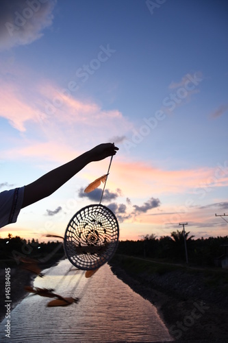 Woman holding dream catcher in the natural beauty.