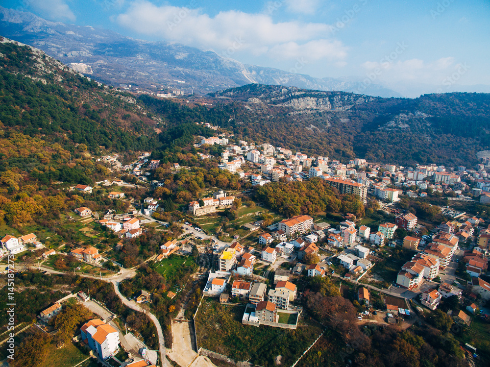 The central part of the modern town of Budva with hotels and high-rise buildings. Aerial view. Europe