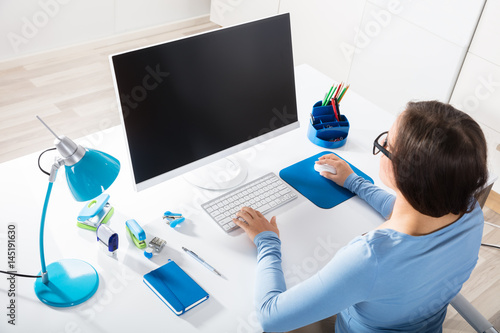 Businesswoman Using Computer On Desk