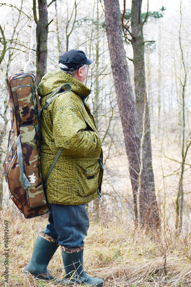 Mature caucasian man with backpack in the forest
