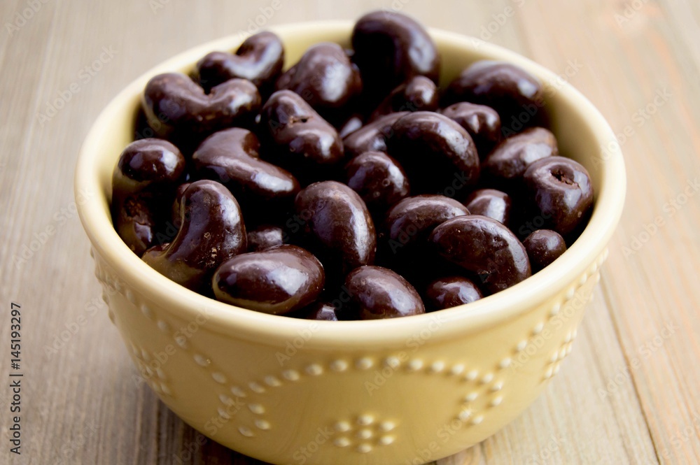 Chocolate covered cashews in a pretty bowl Chocolate covered cashews in a pretty bowl