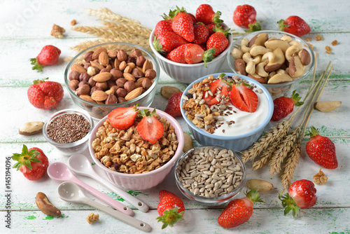 Muesli, nuts, yogurt and cereals on a white background