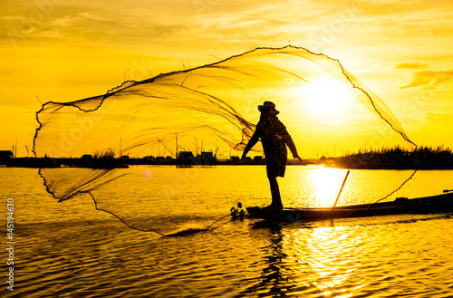 Silhouette Fisherman in action fishing 