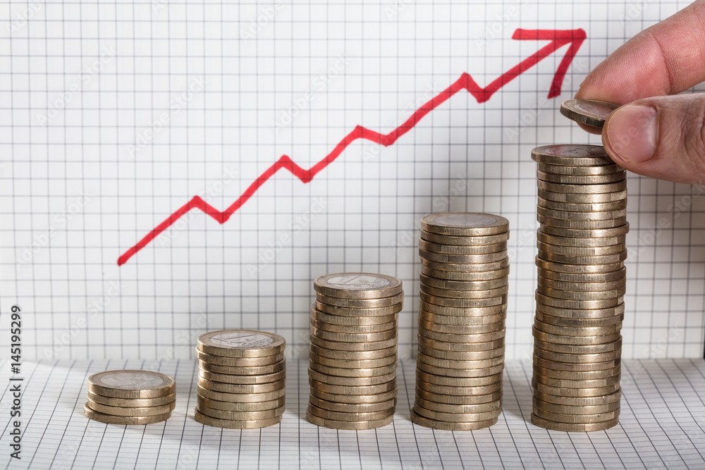 Person Inserting Coin On Coin Stacked With Arrow Showing Profit Person Inserting Coin On Coin Stacked With Arrow Showing Profit