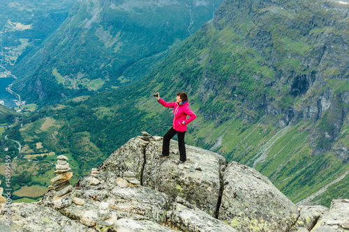 Tourist taking photo from Dalsnibba viewpoint Norway