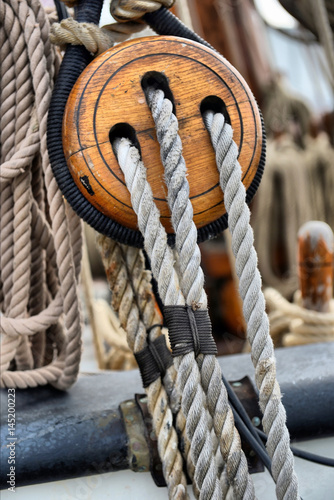 Ancient wooden sailboat pulleys and ropes detail