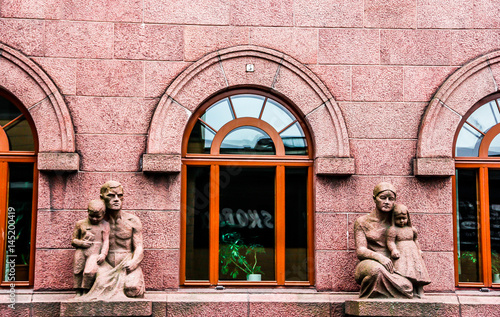 Sculptures of the man and woman with children as a decoration of the building. Porvoo, Finland