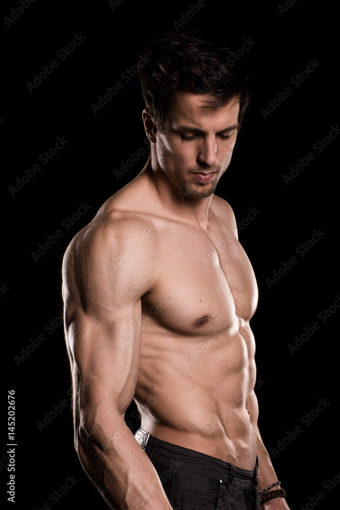 Sexy Shirtless Muscular Male Model on Black Background Sexy Shirtless Muscular Male Model on Black Background