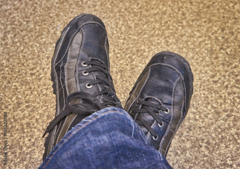 Men's feet in shoes brown color Men's feet in shoes brown color
