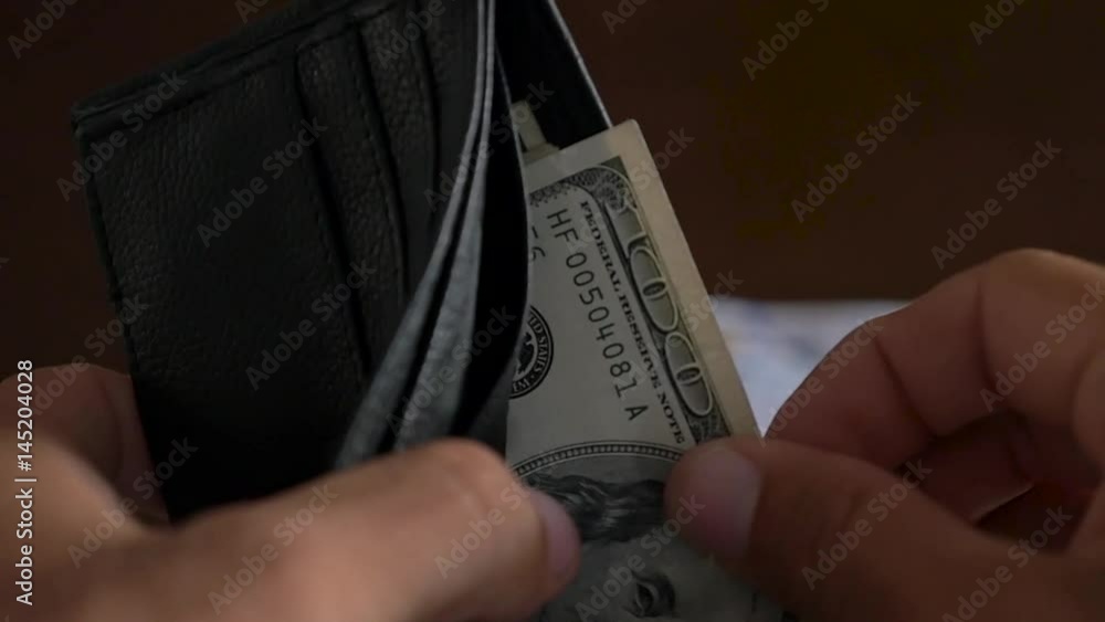 Slow Motion Close-up of a businessman hands counting hundred dollar bill