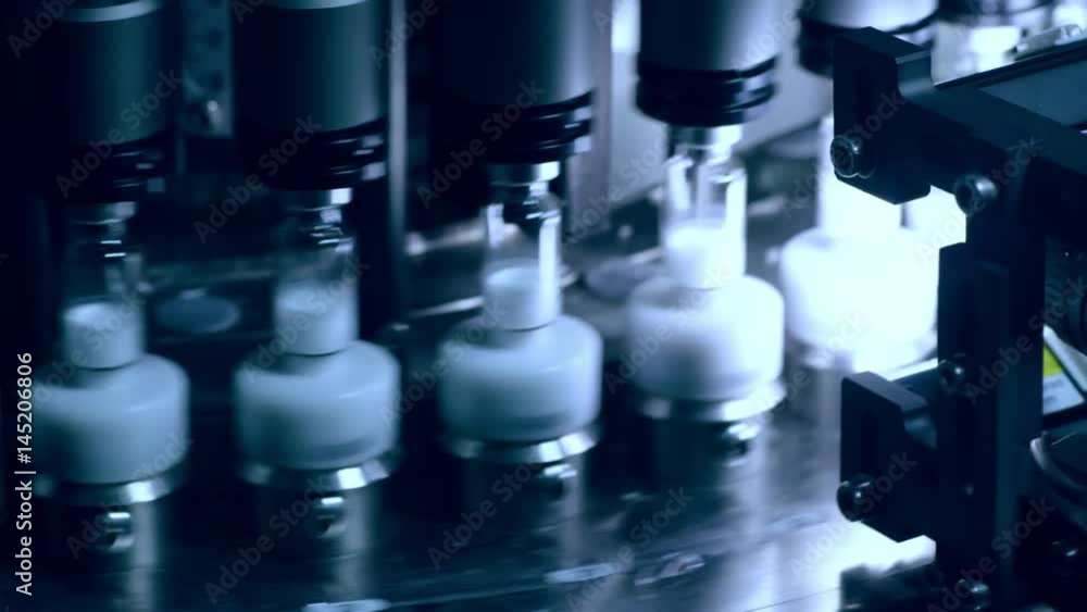 Medical vials on automated production line. Closeup of ampoules on