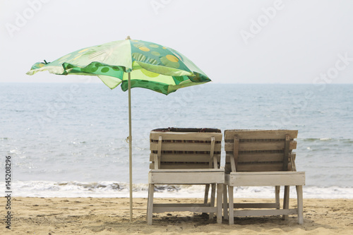Chairs with Umbrella on the beach near ocean