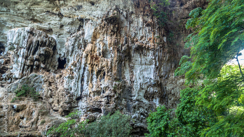 aerial photography above amazing cave. Tham Than Lod Yai is the big cave and have one hole on the top of the cave. it is a short cave there have waterfall pass inside through to another cave 