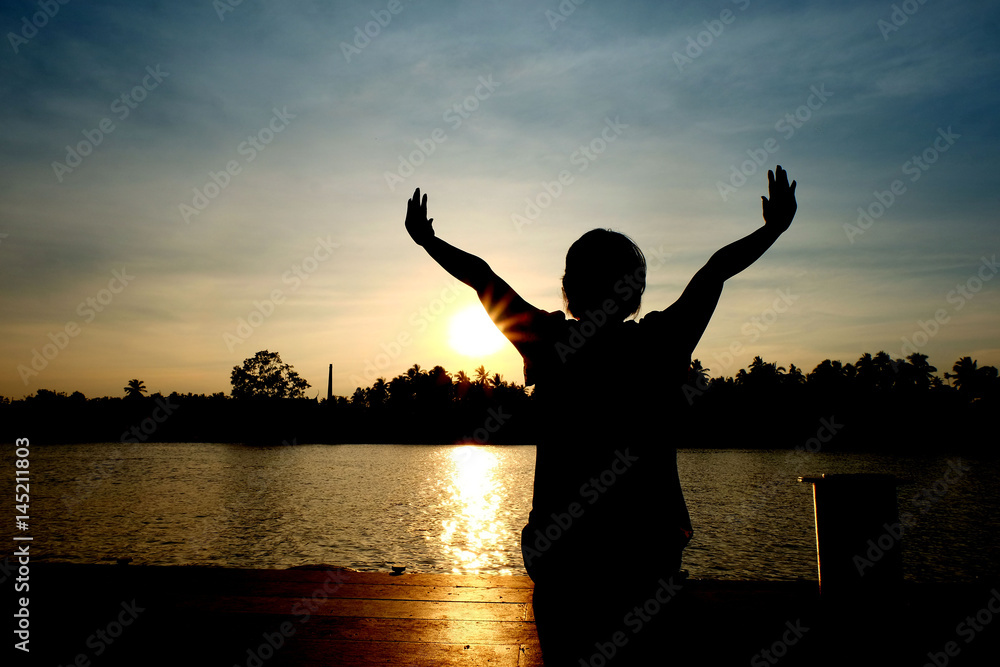 Fototapeta premium Silhouette of one woman sit near the river