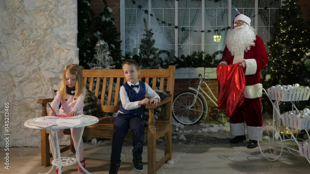 Kids Are Waiting For Gifts From Santa Claus Christmas Interior of the Room Children at Home Family Holiday or New Year Entertainment in Kindergarten Kids Are Waiting For Gifts From Santa Claus Christmas Interior of the Room Children at Home Family Holiday or New Year Entertainment in Kindergarten