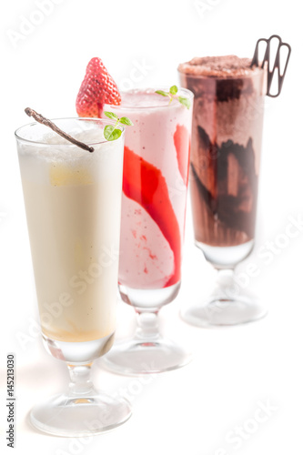 Strawberry, chocolate and vanilla smoothies on white background