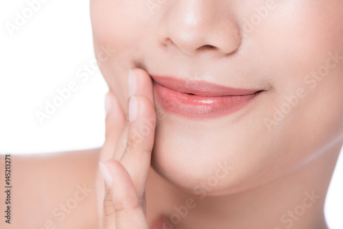 Closeup of beautiful young woman touching her lip by finger
