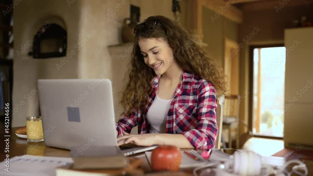 Teenage girl at home, working on notebook, studying Teenage girl at home, working on notebook, studying