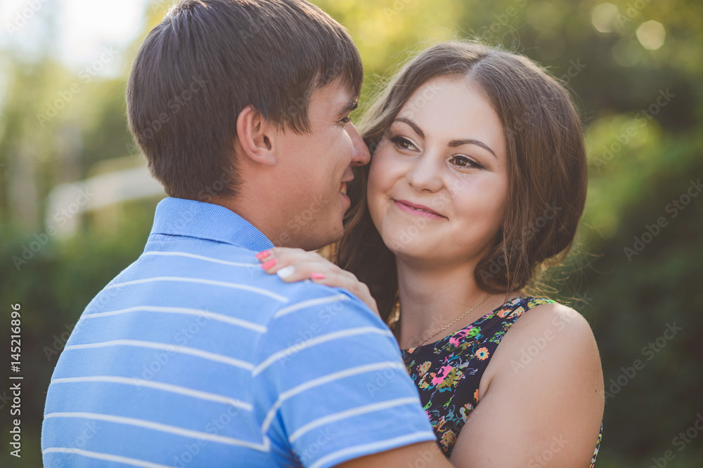 Couple in love hugging against the background of nature. Closeup Couple in love hugging against the background of nature. Closeup