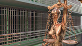Prison bars and Lady of Justice 3d rendering