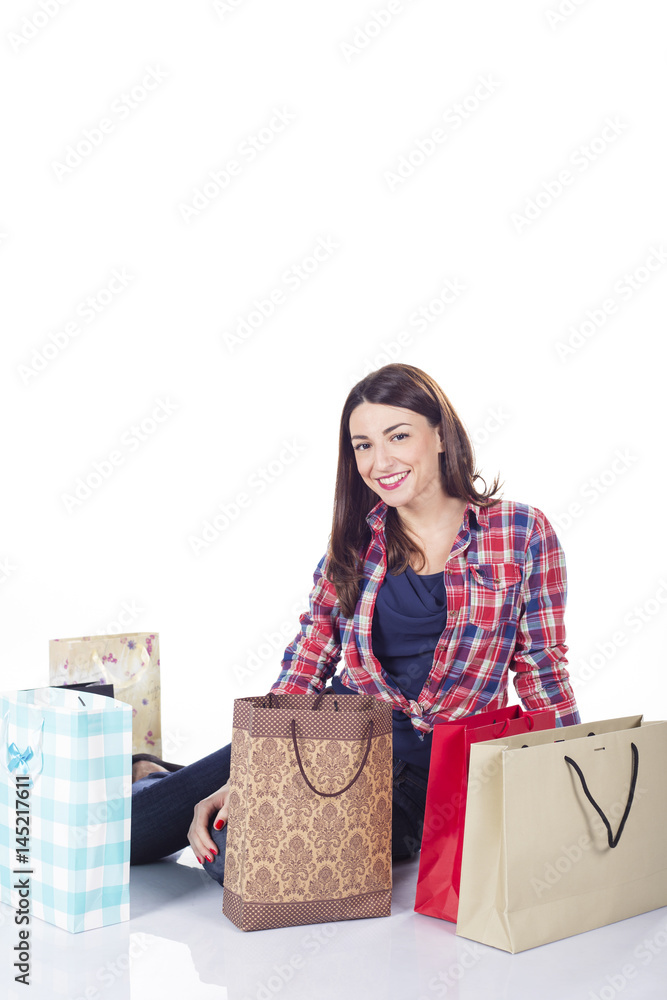 Happy shopping woman smiling - isolated over white background Happy shopping woman smiling - isolated over white background