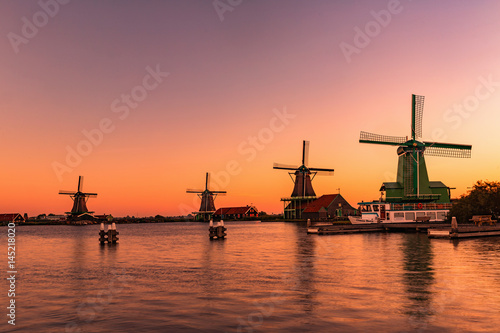 Traditional Dutch windmills in Zaanse Schans in sunrise time, Amsterdam area, Holland