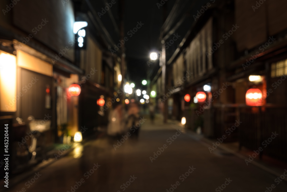 Abstract blur wooden store and restaurant with lighted lanterns at night in Kyoto, Japan