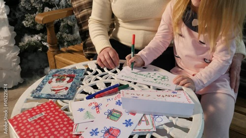 Grandma and Kid Making Christmas Postcards Drawing Together New Year Lights in Cosy Room Family Holiday at Home Traditional Attributes of Christmas Eve