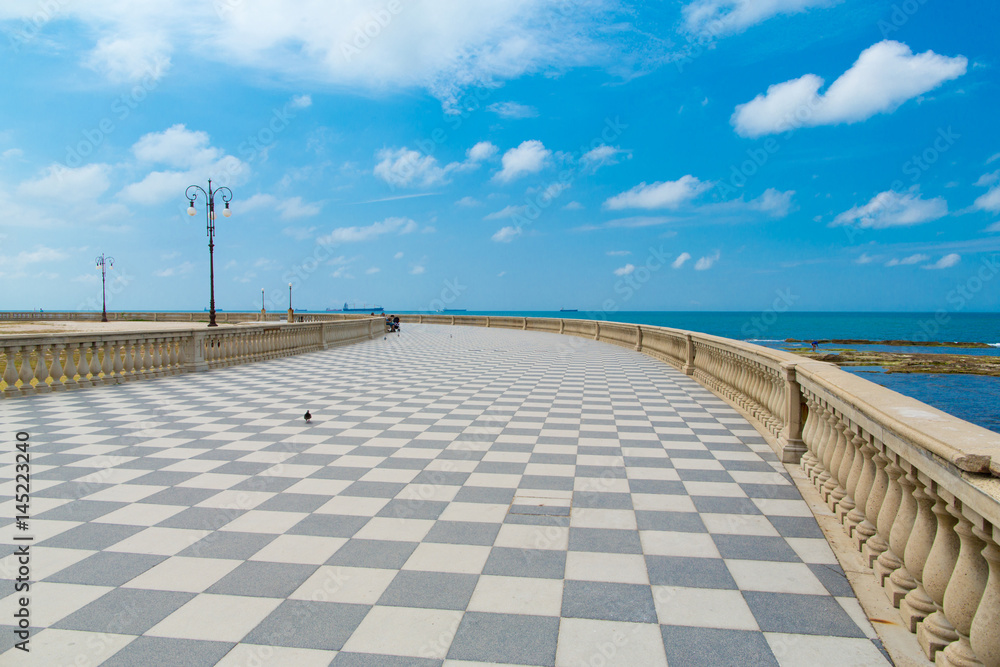 Seaside promenade in Livorno. Black and white tiles in a checkers right