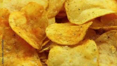 Potato chips food background. Closeup of slowly rotating potato chips