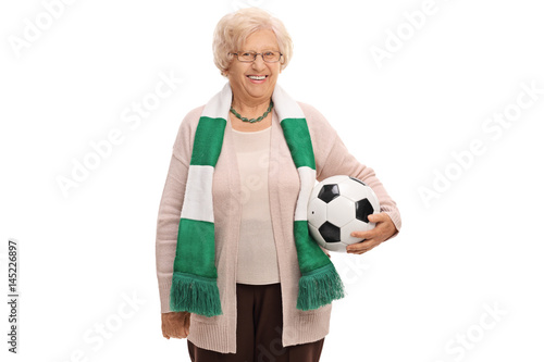Happy elderly soccer fan with a scarf and a football © Ljupco Smokovski