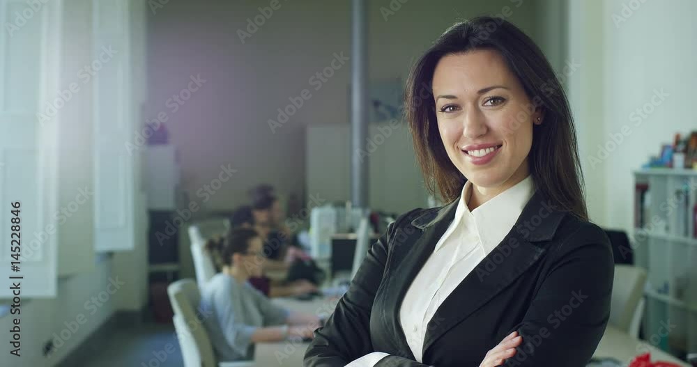 Successful business woman in the office, smiling at the camera, trading and selling (stock). Concept: career growth, work in the office, business affairs,marketing, achievement,colleagues and partners Successful business woman in the office, smiling at the camera, trading and selling (stock). Concept: career growth, work in the office, business affairs,marketing, achievement,colleagues and partners