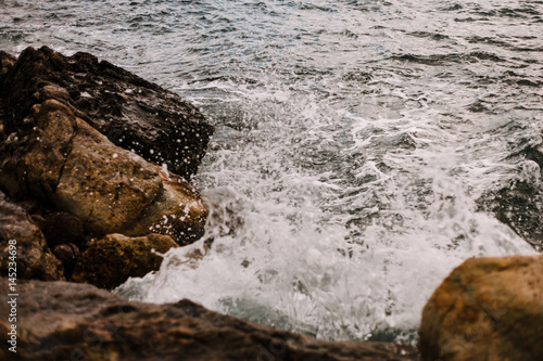 Waves hitting the rocks Mykonos island