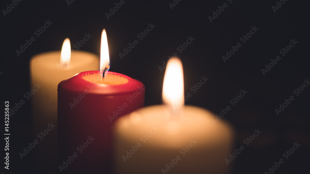 A lit candles on a table in a dining room A lit candles on a table in a dining room