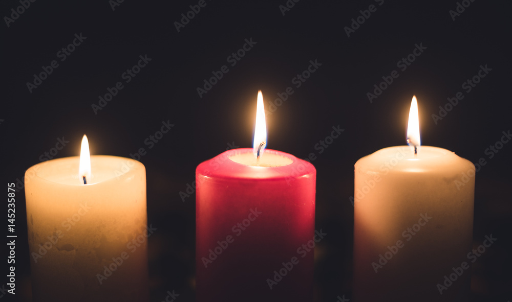 A lit candles on a table in a dining room