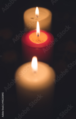 A lit candles on a table in a dining room
