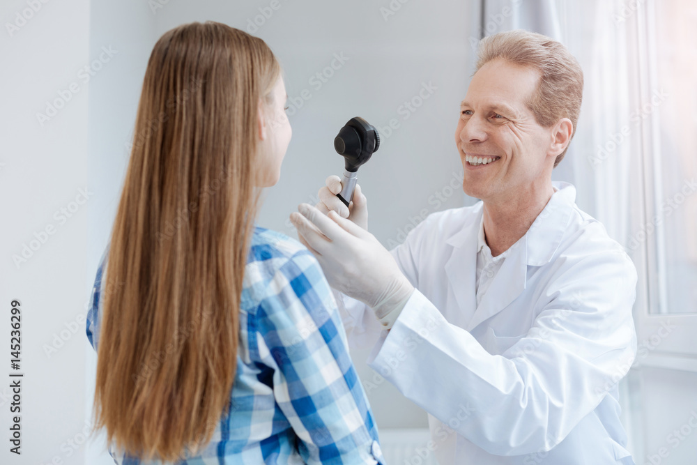 Happy doctor using special equipment in the clinic Happy doctor using special equipment in the clinic